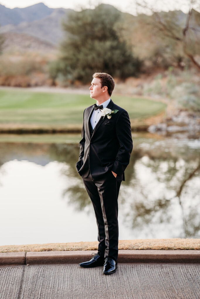 Groom posing ideas, Groom in front of lake at verrado gold club, arizona wedding photographer