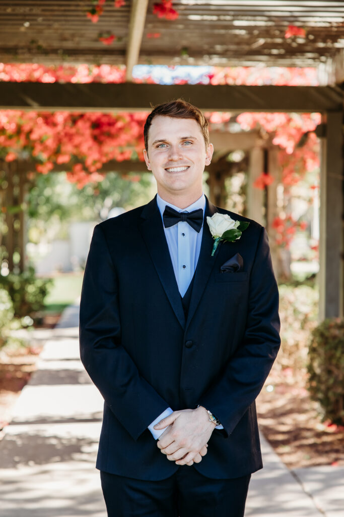 Groom posing ideas, Groom under veranda with bougainvillea, arizona wedding photographer, groom in black tux