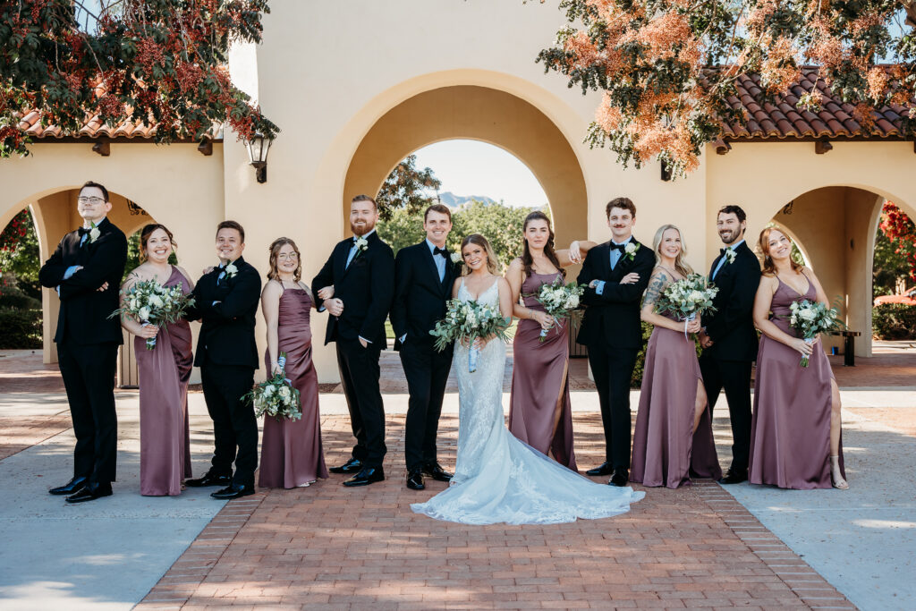 wedding party posing ideas, groomsmen in black tux, bridemaids in muted purple dresses, verrado golf club wedding, arizona wedding photographer