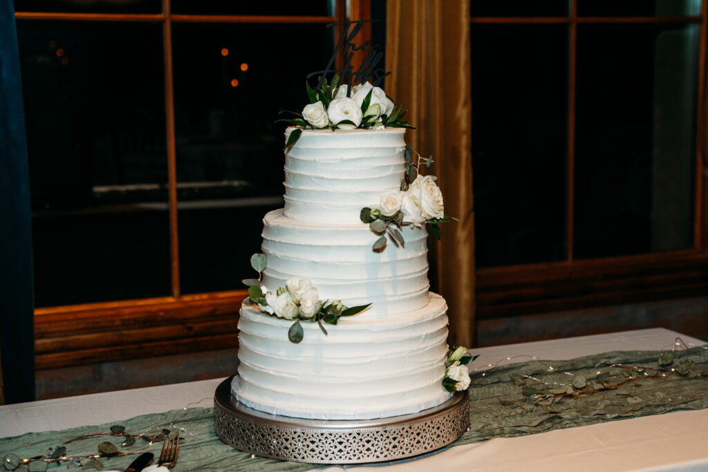 wedding details, three tiered white wedding cake with roses, simple wedding cake